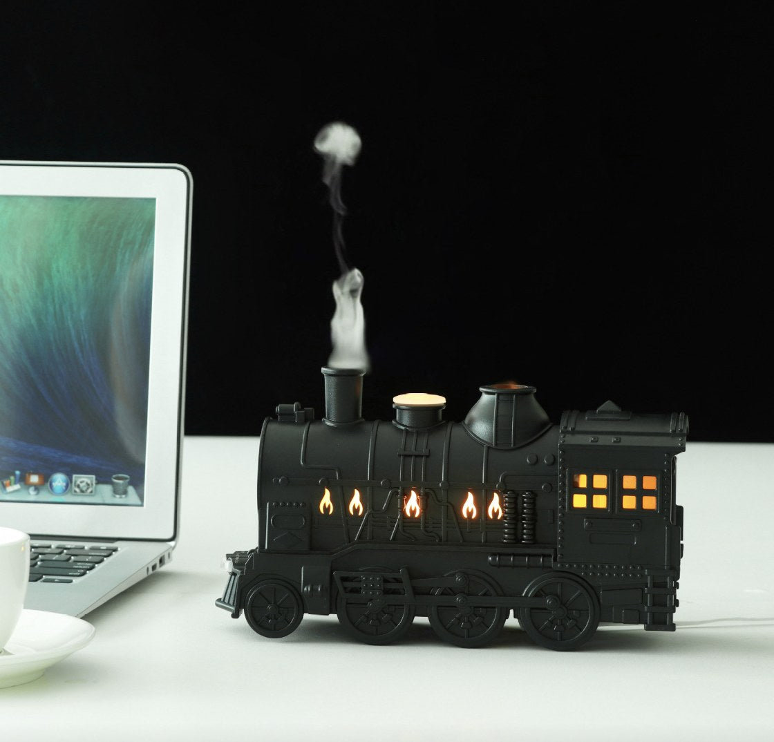 Matte Black train humidifier puffing mist on a desk